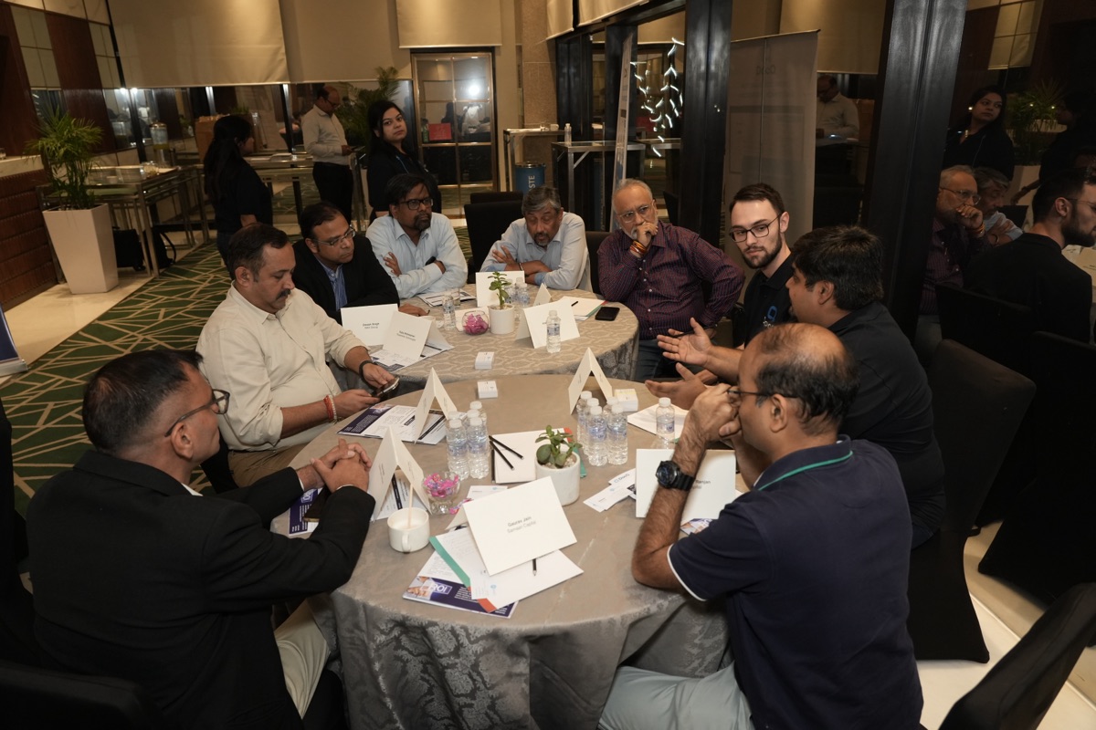 Full roundtable in session with attendees and DocQ team members in animated discussion